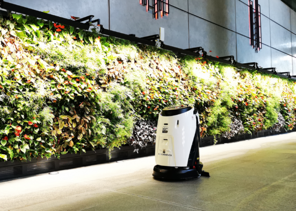 ICE Robotic machine cleaning alongside a living plant wall